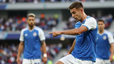 A photorealistic image of a 24-year-old right-back in a blue jersey with white sleeves and white shorts, playing a pass...
