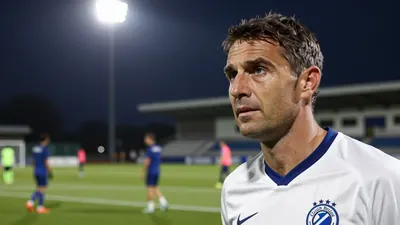A tight action crop of a 35-year-old male coach in a white Club Brugge jersey with a blue collar, shot with a 50mm f/1.4...