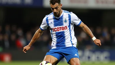 A photorealistic image of a young, anonymous Portuguese football player in his mid-20s, wearing a blue and white jersey...