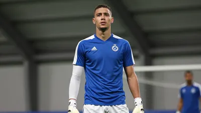 A photorealistic image of an anonymous Club Brugge player in a blue jersey with white sleeves and white shorts, with a...