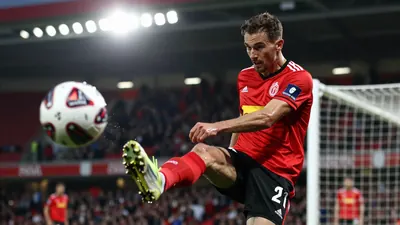A photorealistic image of an anonymous Club Brugge player, aged 25-30, with a rugged build, in a red jersey and black...