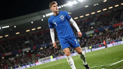 A photorealistic image of an anonymous 23-year-old Dutch left-back in a blue jersey with white sleeves, wearing a white...